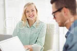 Portrait of smiling woman sitting on chair