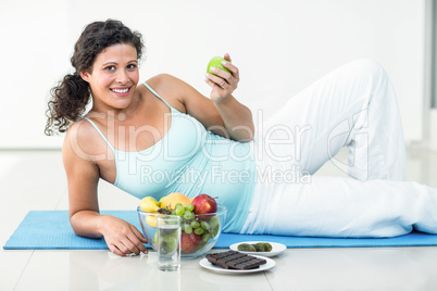 Portrait of pregnant woman holding an apple