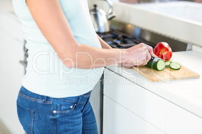 Midsection of woman cutting vegetables