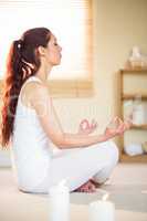 Side view of woman meditating with eyes closed