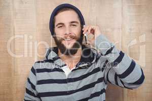 Hipster with hooded shirt using mobile phone