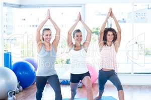 Smiling women with hands joined overhead