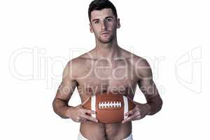Portrait of shirtless rugby player with the ball