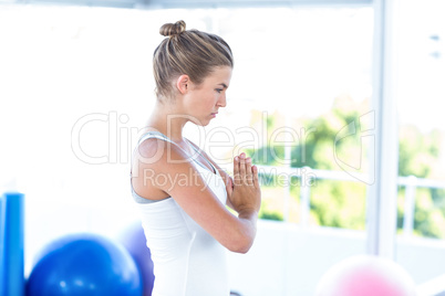 Side view of woman with hands joined