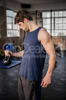 Muscular man lifting kettlebell