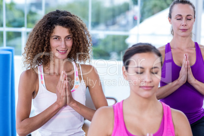 High angle view of women meditating with joined hands