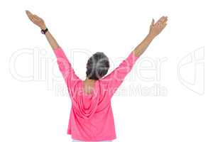 Rear view of mature woman with arms raised