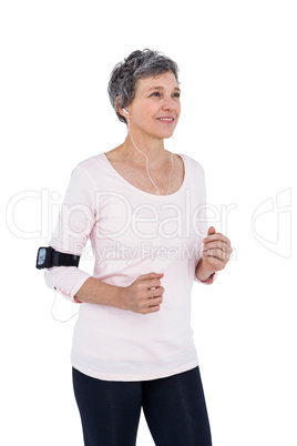 Mature woman listening music while exercising