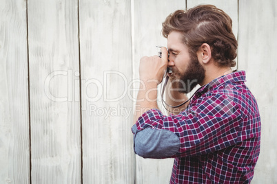 Side view of hipster photographing with camera