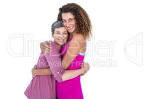 Portrait of cheerful daughter hugging mother