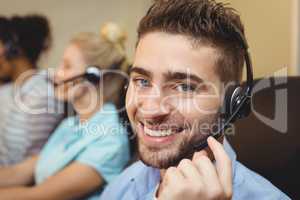 Portrait of smiling executive in call center