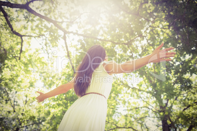 Low angle view of long hair woman with arms outstretched