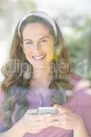 Portrait of happy woman with smartphone