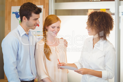 Business woman holding paper and pen during meeting