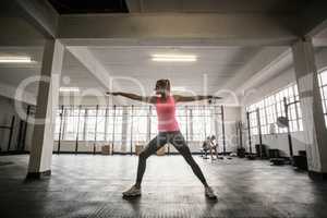 Fit woman doing stretching exercise