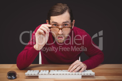 Surprised creative businessman working at desk