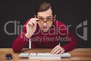 Surprised creative businessman working at desk