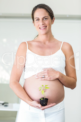 Portrait of happy woman with plant