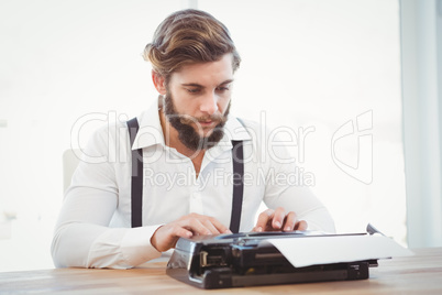 Hipster working on typewriter