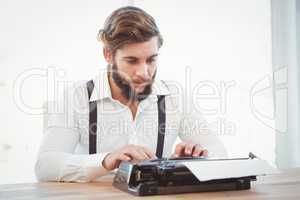 Hipster working on typewriter