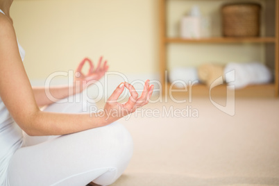 Mid section of woman meditating