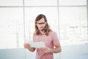 Confident hipster looking at documents