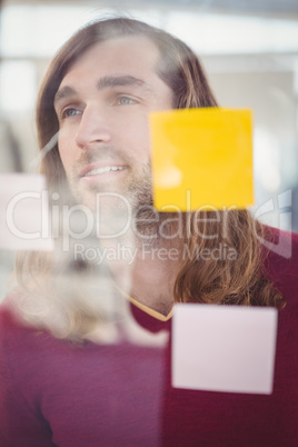 Confident businessman standing in front of sticky notes