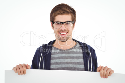 Portrait of man wearing eye glasses holding billboard