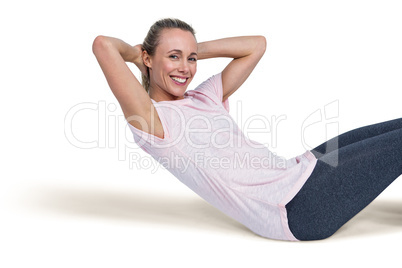 Portrait of happy sporty woman doing sit ups