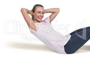 Portrait of happy sporty woman doing sit ups