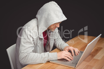 Businessman with hooded shirt working on laptop