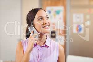 Businesswoman looking away while talking on phone