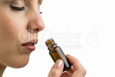 Close-up of female patient smelling medicine bottle