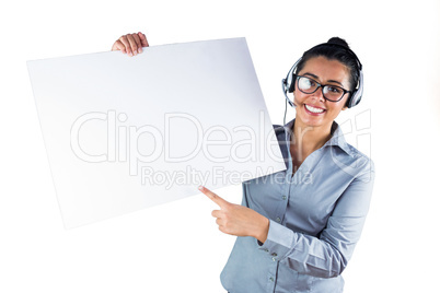Smiling businesswoman wearing headset and holding white sheet