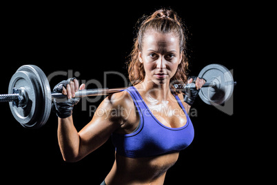 Portrait of confident woman lifting crossfit