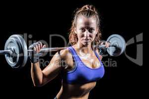 Portrait of confident woman lifting crossfit