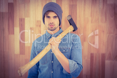 Portrait of confident hipster holding axe on shoulder