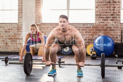 Two fit people working out