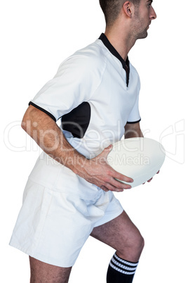 Side view of rugby player holding ball