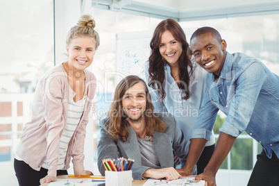 Portrait of happy business team discussing at desk Portrait of happy business team discussing at desk