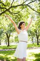 Cheerful woman with arms raised