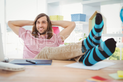 Hipster realaxing with legs on desk
