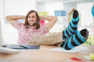 Hipster realaxing with legs on desk