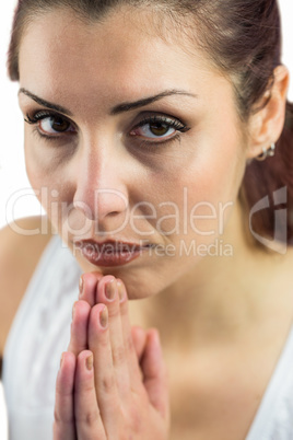 Portrait of confident woman with joined hands