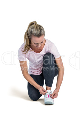 Sporty woman tying shoelace