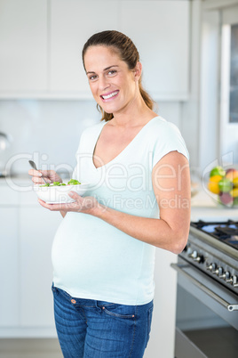 Portrait of happy woman with salad