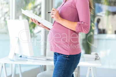 Midsection of businesswoman with documents at home