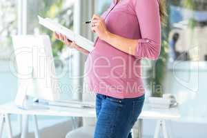 Midsection of businesswoman with documents at home