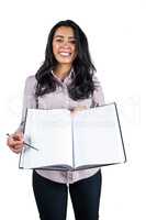 Businesswoman holding a business ledger and a pen