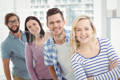 Portrait of smiling business professionals standing in row